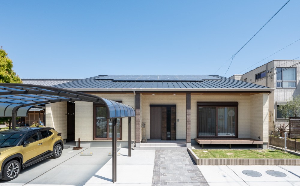 稲沢市K様邸の外観。太陽光パネルを載せた寄棟屋根の平屋と、カーポート